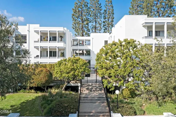 a large building with a mountain in the background