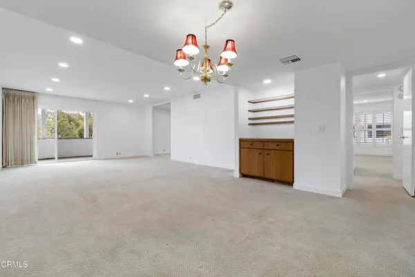a view of a room with chandelier chandelier and windows