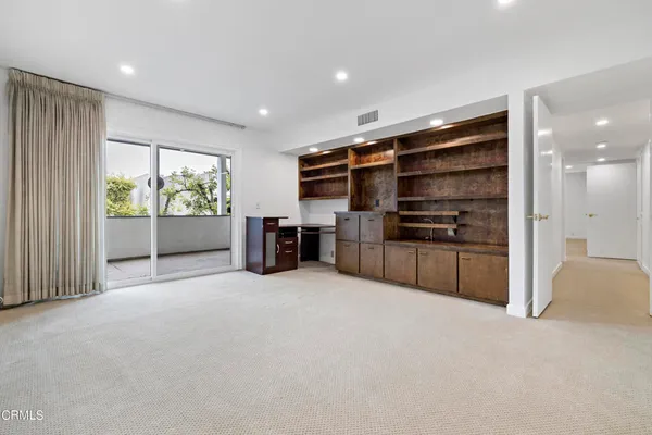 a view of an empty room with closet