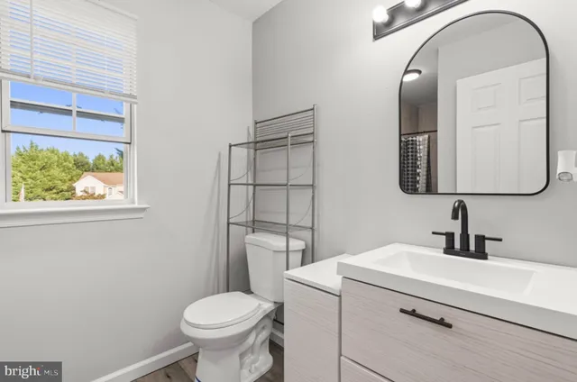 a bathroom with a toilet sink and mirror