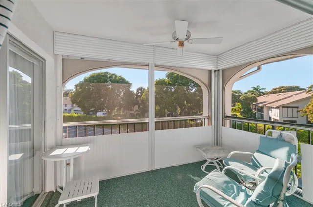 a view of a porch with furniture and a yard