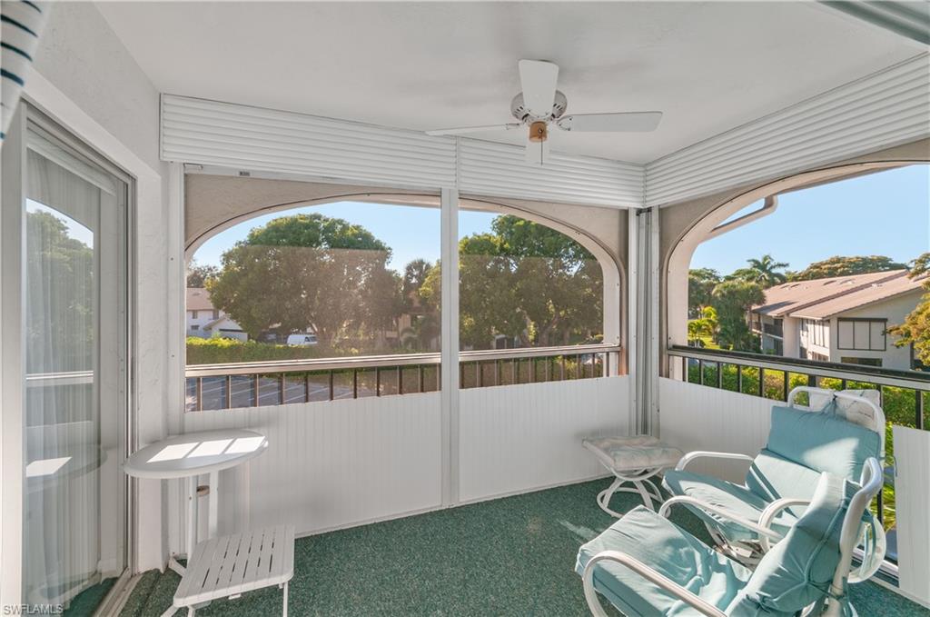 5 High Point Circle West, Unit 301 Naples, FL 34103 - Photo 11 of 37 a view of a porch with furniture and a yard