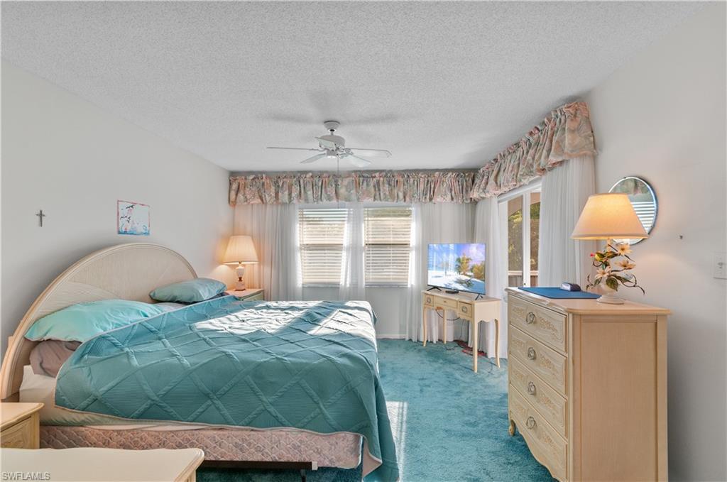5 High Point Circle West, Unit 301 Naples, FL 34103 - Photo 15 of 37 a bedroom with a bed mirror and window