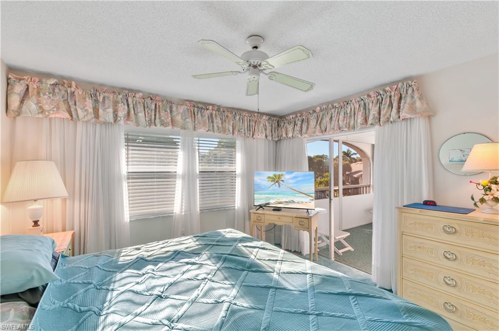 5 High Point Circle West, Unit 301 Naples, FL 34103 - Photo 16 of 37 a bedroom with a large bed and a window