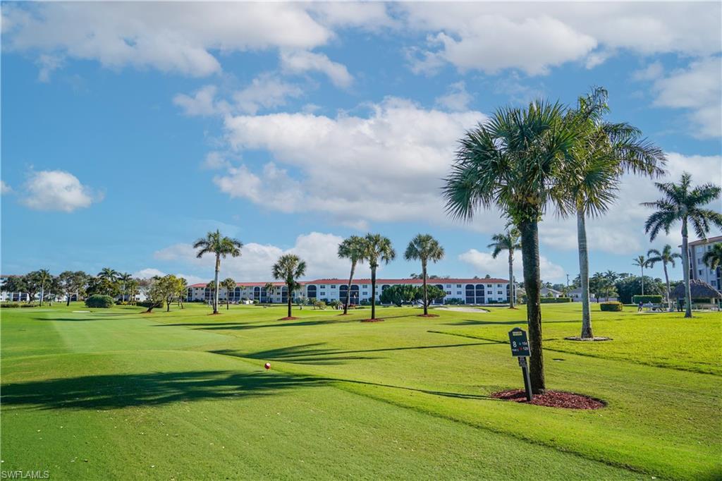 5 High Point Circle West, Unit 301 Naples, FL 34103 - Photo 23 of 37 a view of a park with swings and slides