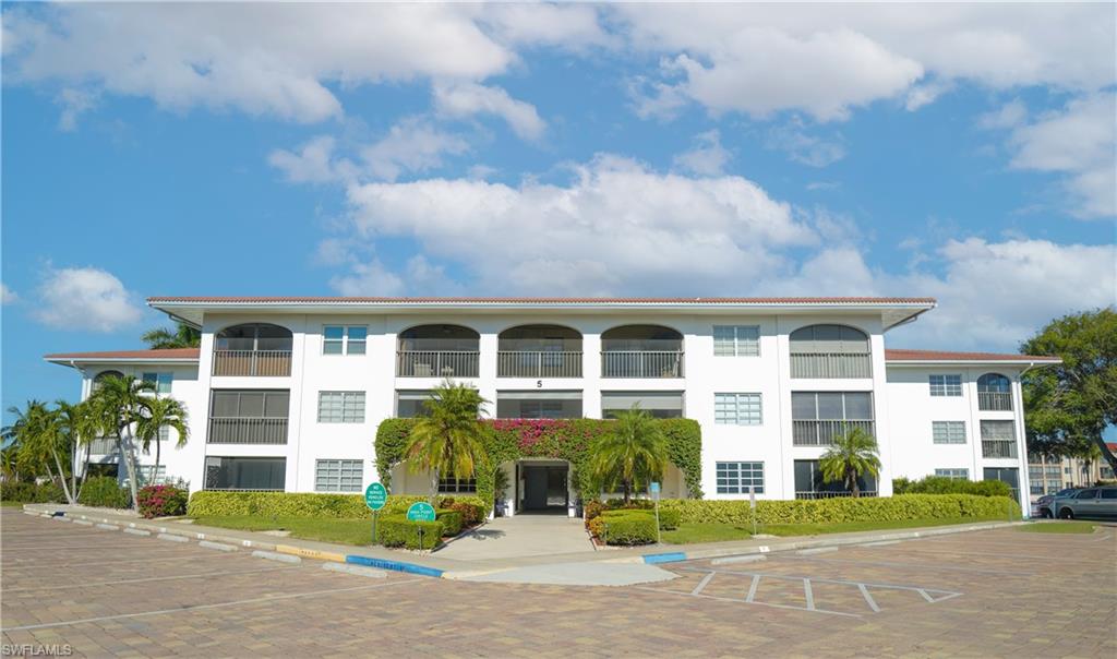 5 High Point Circle West, Unit 301 Naples, FL 34103 - Photo 37 of 37 front view of house with a yard