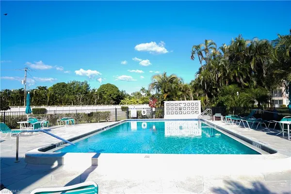 a view of a swimming pool with lounge chairs