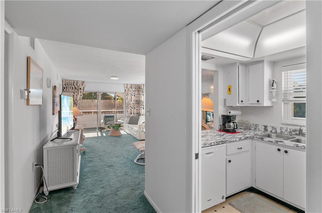 5 High Point Circle West, Unit 301 Naples, FL 34103 - Photo 5 of 37 a view of a kitchen with appliances and cabinets