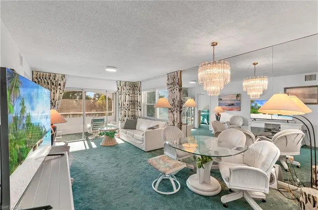 a very nice looking dining room with furniture a rug and wooden floor