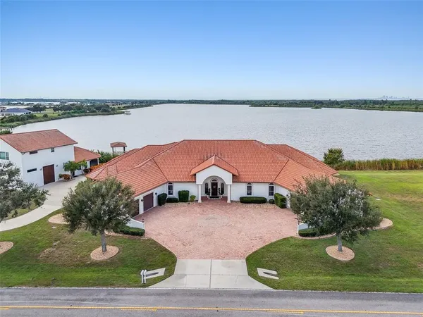 a view of a house with a yard and sitting area