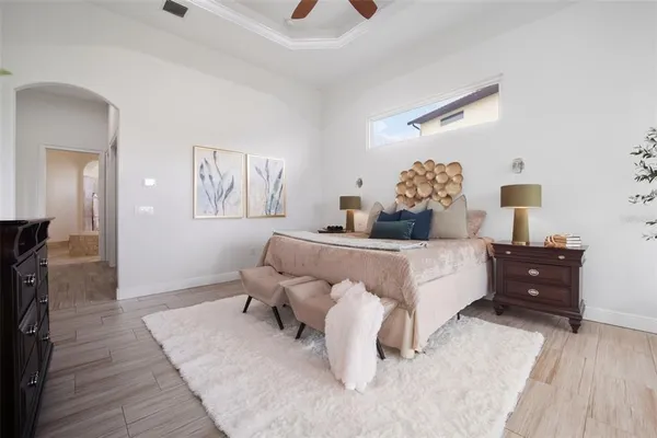 a living room with furniture and a large window with kitchen view