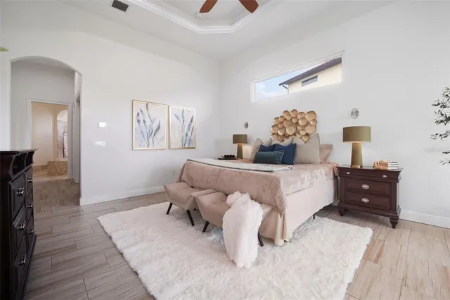 a living room with furniture and a large window with kitchen view