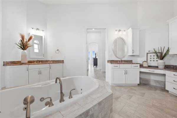 a spacious bathroom with a double vanity sink a mirror and a shower