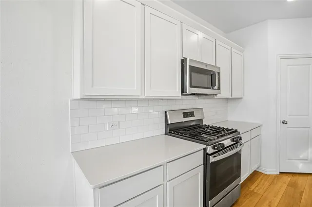 a kitchen with a stove and cabinets