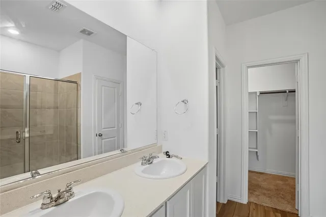 an empty room with ceiling fan and window