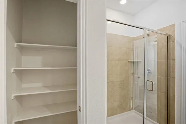 a bathroom with a shower and a sink