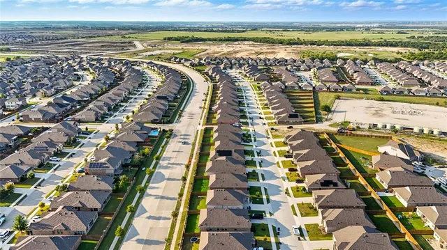 an aerial view of a house with a big yard