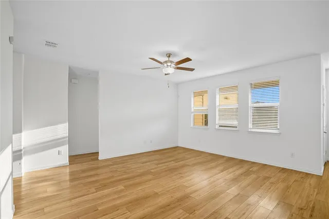 a view of kitchen with stainless steel appliances refrigerator stove microwave and cabinets