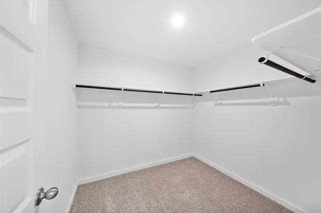 a spacious bathroom with a shower a sink and a mirror