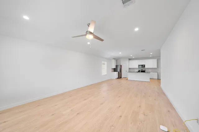 a view of a kitchen with a sink and a window