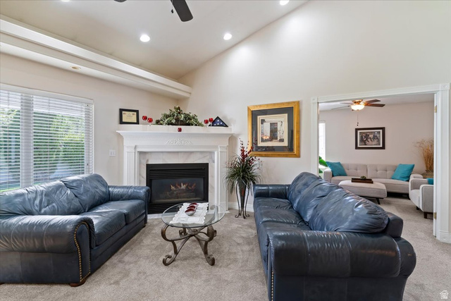 1924 North 2000th Street East Layton, UT 84040 - Photo 13 of 41 Carpeted living room featuring a ceiling fan, vaulted ceiling, a premium fireplace, and recessed lighting