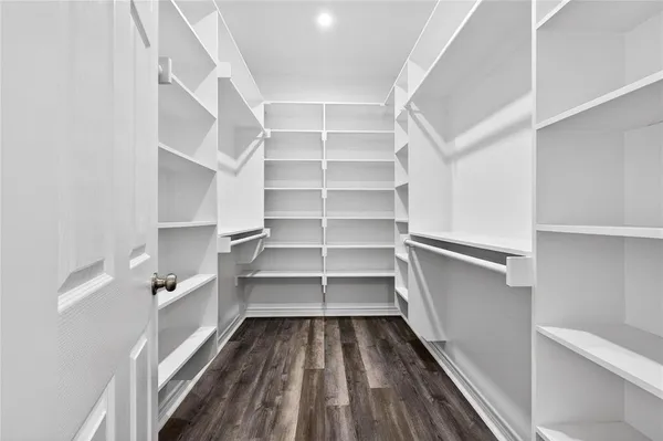 a view of walk in closet with empty racks