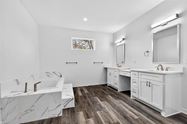 a spacious bathroom with a sink and a large mirror