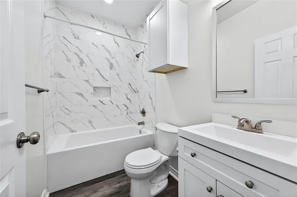 a bathroom with a sink toilet and shower