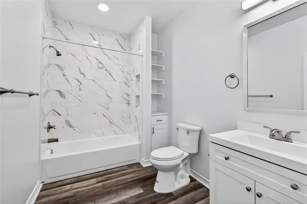 a bathroom with a toilet and a bathtub