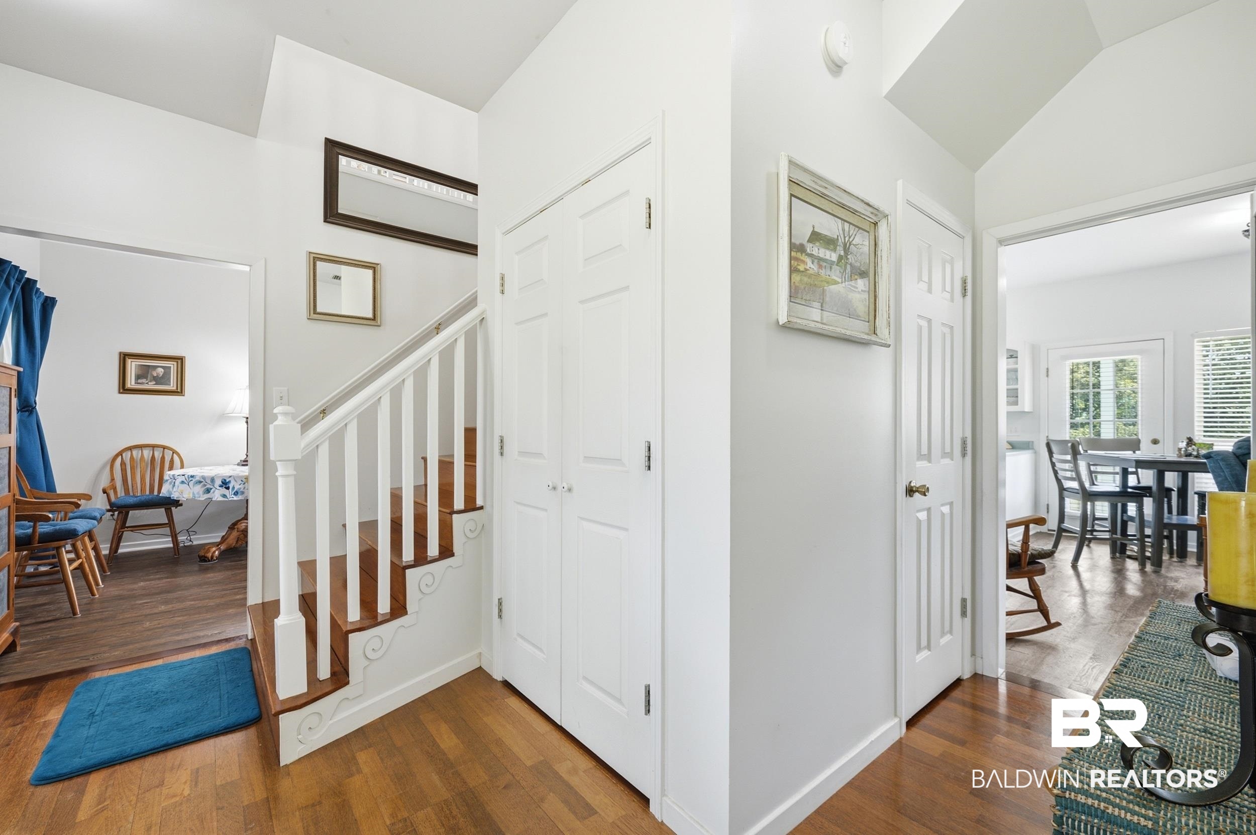 15855 Calvin Richerson Road Bay Minette, AL 36507 - Photo 39 of 83 Foyer featuring hardwood flooring, white-painted staircase with wood-finish treads, and white paneled doors