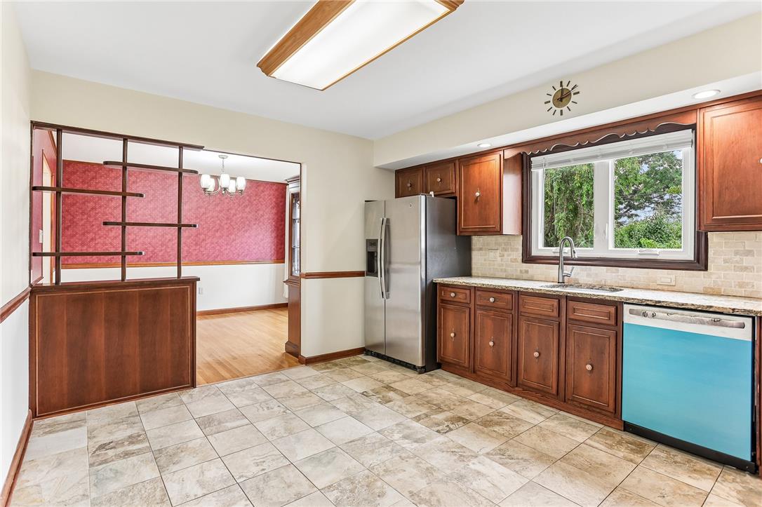 3659 Ironstone Road Bethlehem, PA 18020 - Photo 21 of 52 A well-lit kitchen with classic wood cabinetry and durable tiled flooring flows into an adjacent dining area.