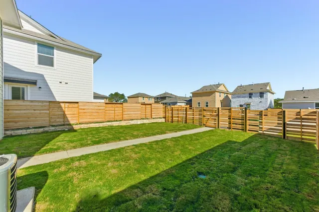 a view of a house with a yard and deck