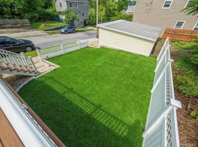 a view of a backyard with sitting area