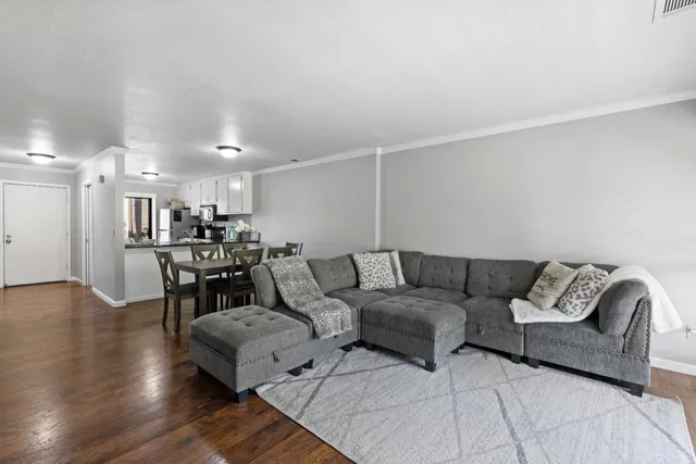a living room with furniture and wooden floor