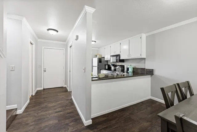 a kitchen with stainless steel appliances granite countertop a refrigerator and a stove top oven