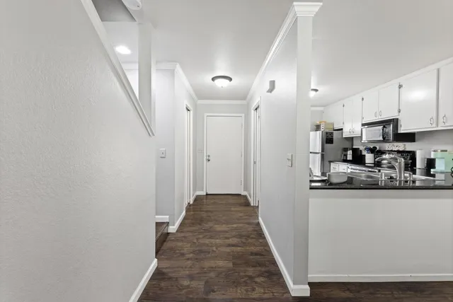 a view of a kitchen with stainless steel appliances granite countertop a refrigerator