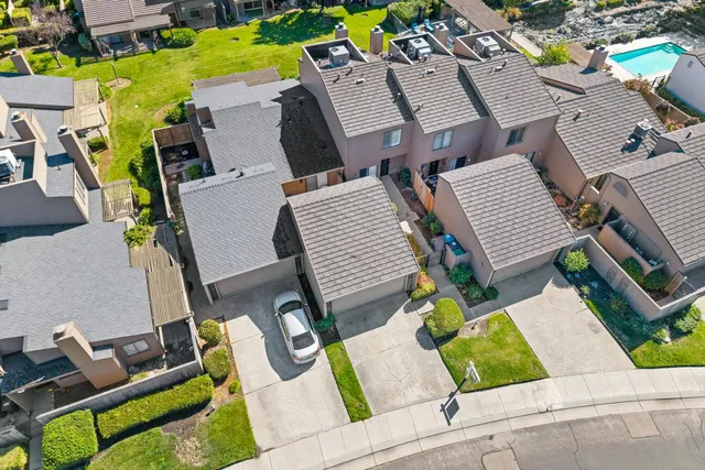 an aerial view of a house with garden space and outdoor seating