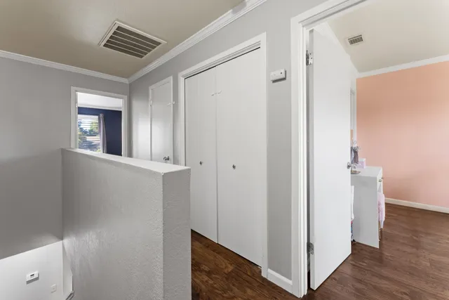 a view of a hallway with wooden floor