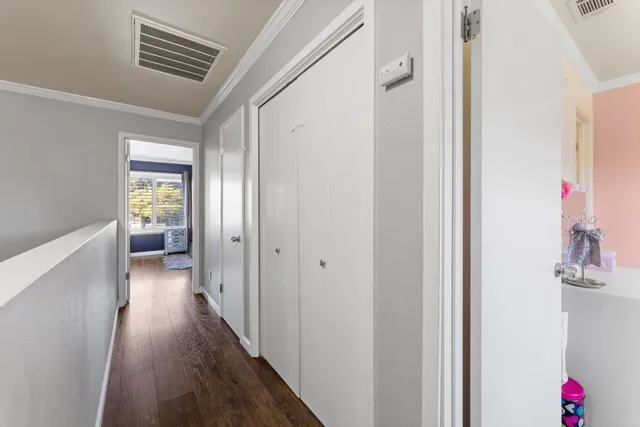 a view of hallway with wooden floor