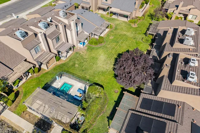 an aerial view of a house with a garden and swimming pool