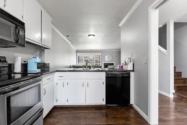 a kitchen with stainless steel appliances granite countertop a refrigerator and a stove top oven