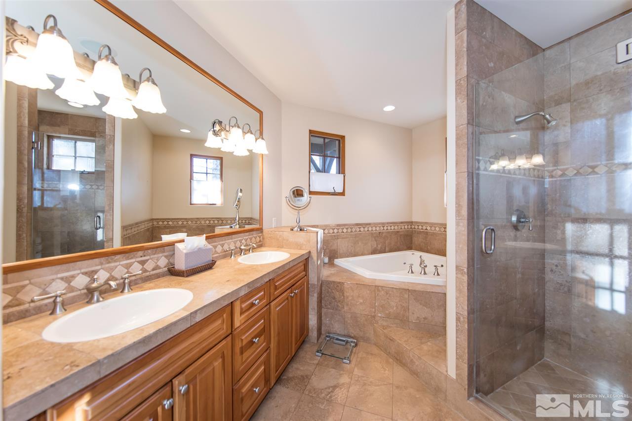 6365 Wetzel Court, Unit MONTRUEX 3 Reno, NV 89511 - Photo 12 of 24 a spacious bathroom with a double vanity sink mirror and a bath tub
