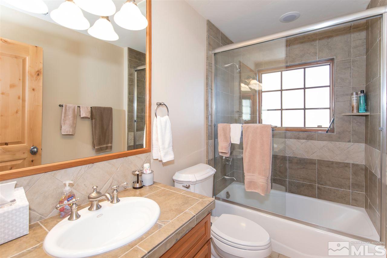 6365 Wetzel Court, Unit MONTRUEX 3 Reno, NV 89511 - Photo 16 of 24 a bathroom with a sink toilet and shower
