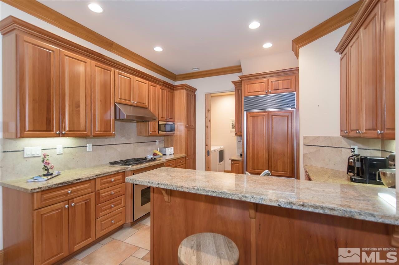 6365 Wetzel Court, Unit MONTRUEX 3 Reno, NV 89511 - Photo 8 of 24 a kitchen with stainless steel appliances granite countertop a sink stove and cabinets