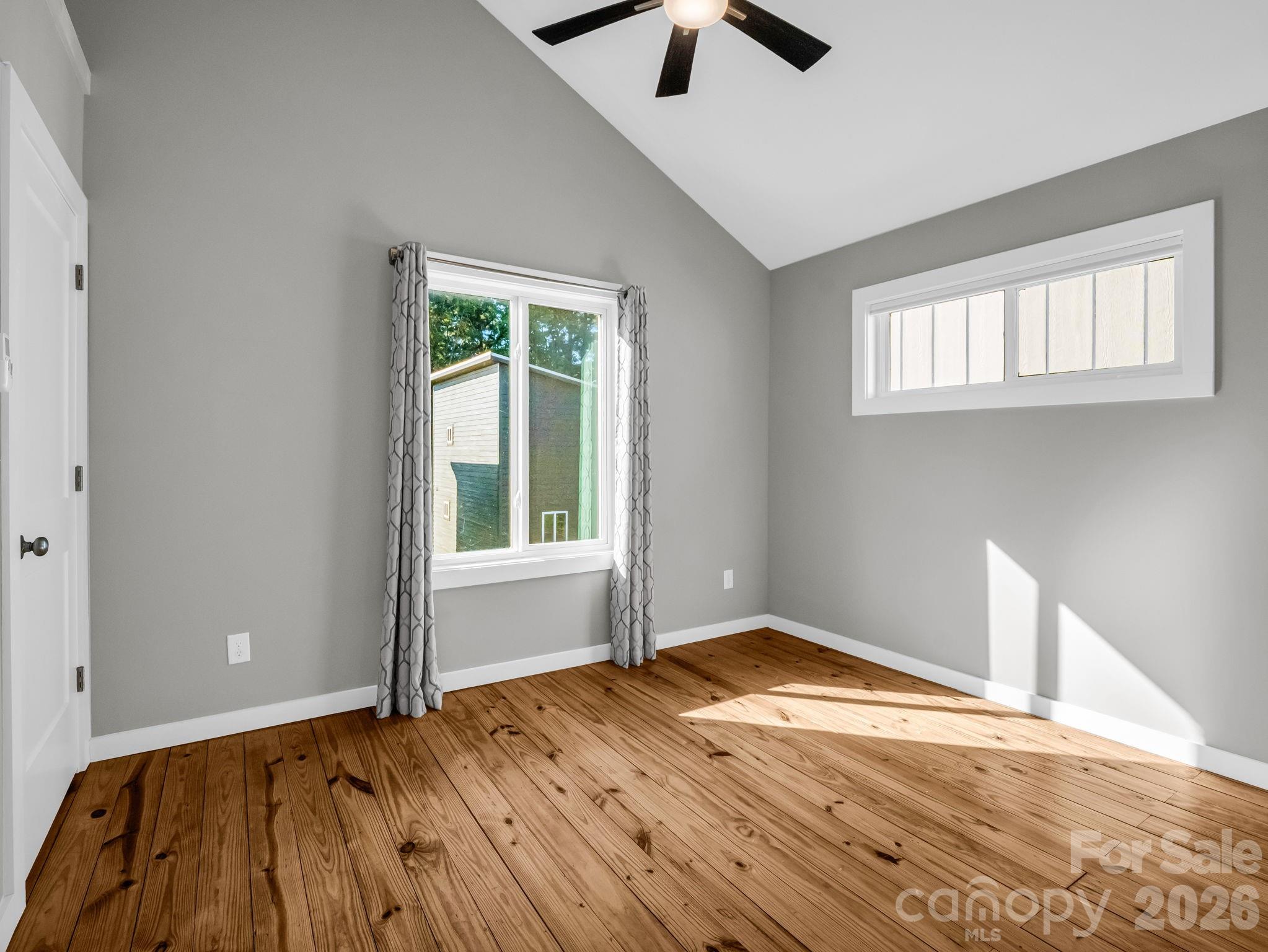 9 East Citra Street Arden, NC 28704 - Photo 11 of 28 an empty room with wooden floor and windows