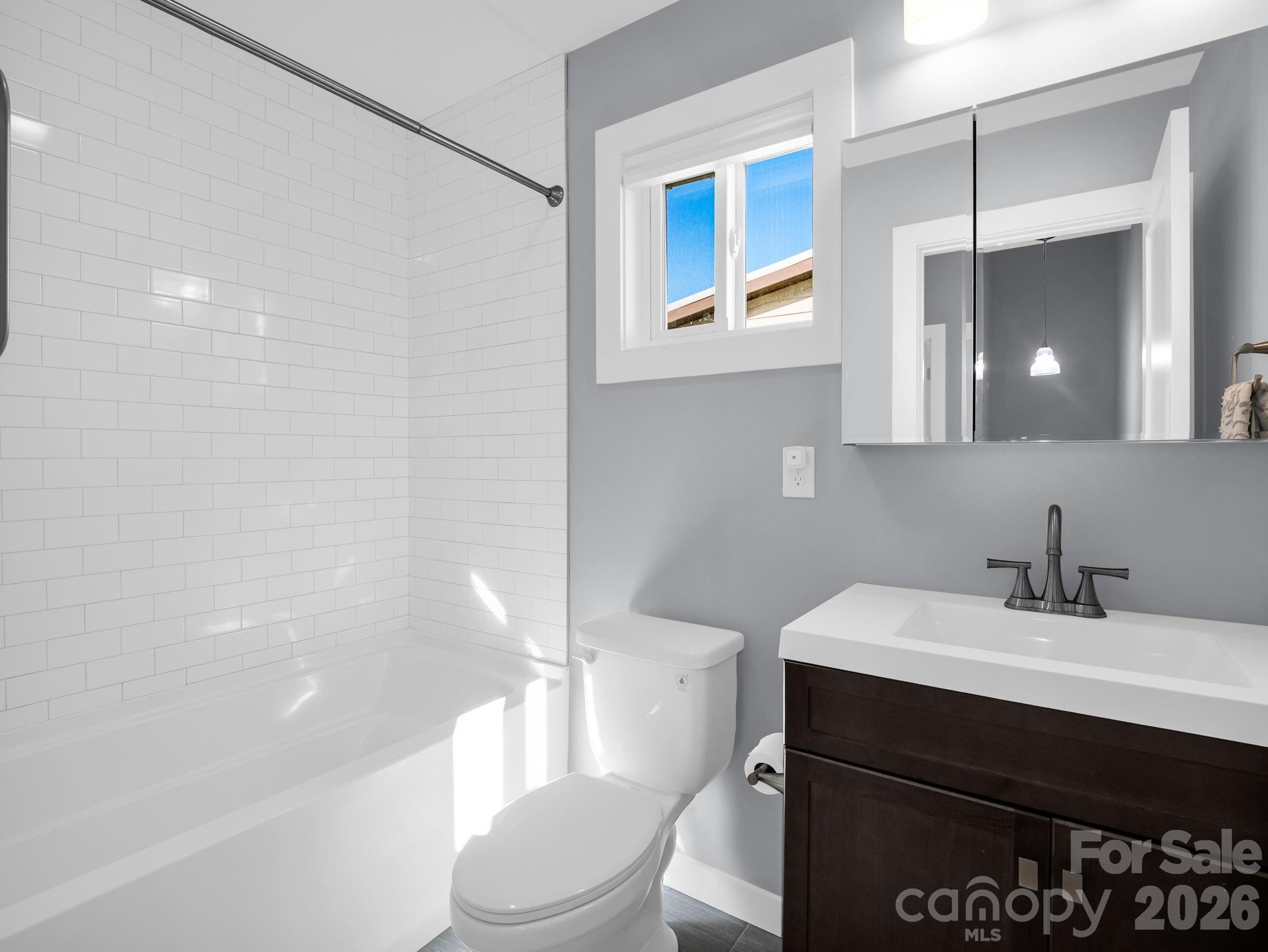 9 East Citra Street Arden, NC 28704 - Photo 13 of 28 a bathroom with a sink a toilet and shower