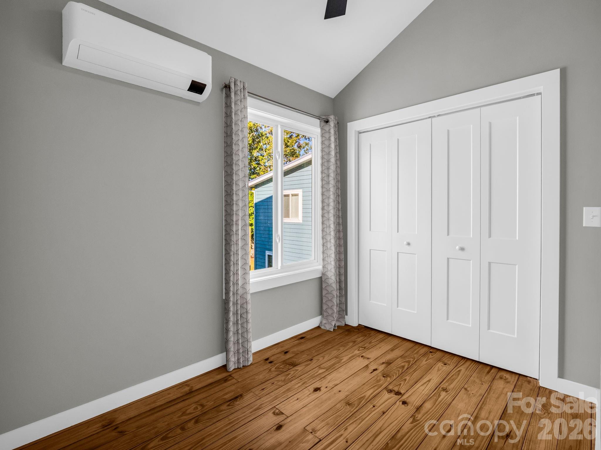 9 East Citra Street Arden, NC 28704 - Photo 14 of 28 a view of an empty room with wooden floor and a window