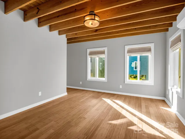 a view of an empty room with windows