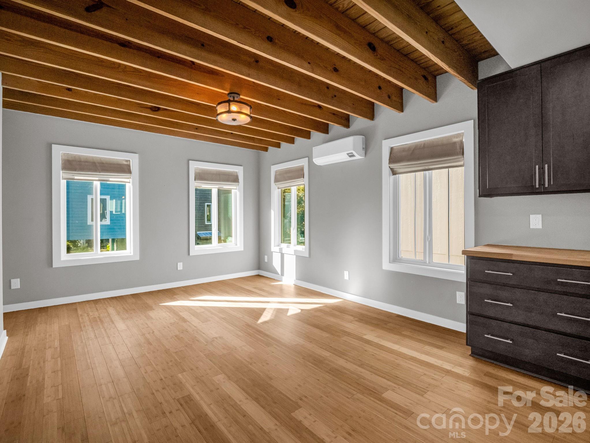 9 East Citra Street Arden, NC 28704 - Photo 4 of 28 a view of an empty room with wooden floor and a window