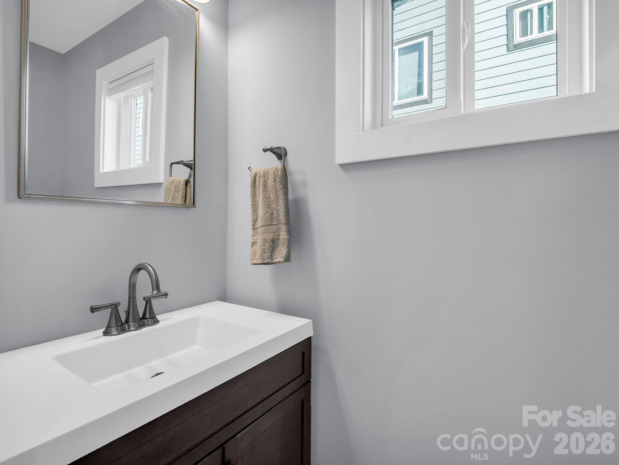 9 East Citra Street Arden, NC 28704 - Photo 9 of 28 a bathroom with a sink and a mirror